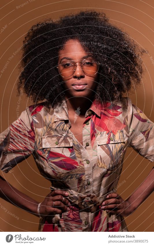 Trendy black model in sunglasses woman exotic ornament trendy cuban studio posture floral ethnic hairstyle african american afro cool human face individuality