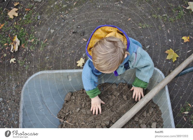 child with wheelbarrow Child Wheelbarrow Garden Gardening out helping hand join in Hand Earth Comprehend right in the middle Nature Gardener Human being Seeds