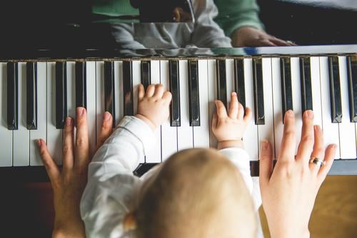 Mother and child make music together at the same time Make music Child Musical instrument early musical education Parenting Family Playing Piano hands in common