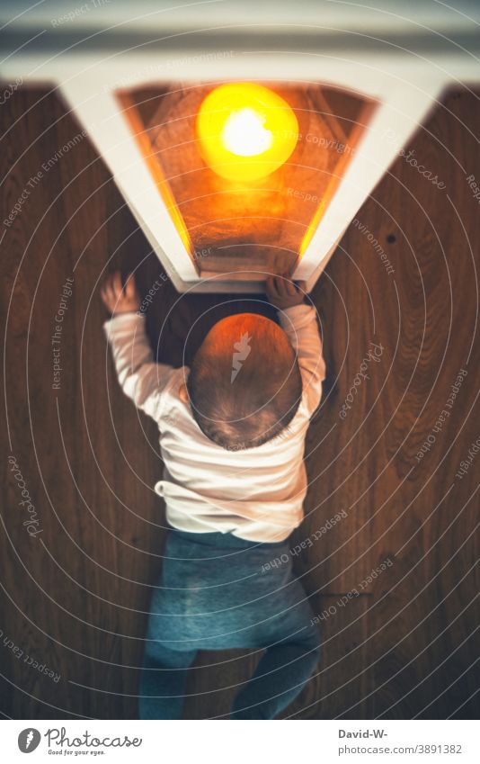 Child fascinated by candlelight in the lantern Toddler Baby Candlelight Fire attractive spellbound Light inquisitorial peril Lantern shoulder stand Illuminate