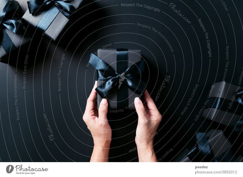 Boxing day Sale concept, woman hand give the gift box on black background 2020 December bag beautiful bow boxing celebrate celebration center christmas country