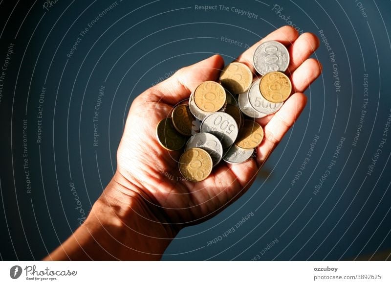 hand holding 500 coins indonesian rupiah Hand Coin Money Financial Industry Cent Paying Save Loose change Economy Financial institution investment savings