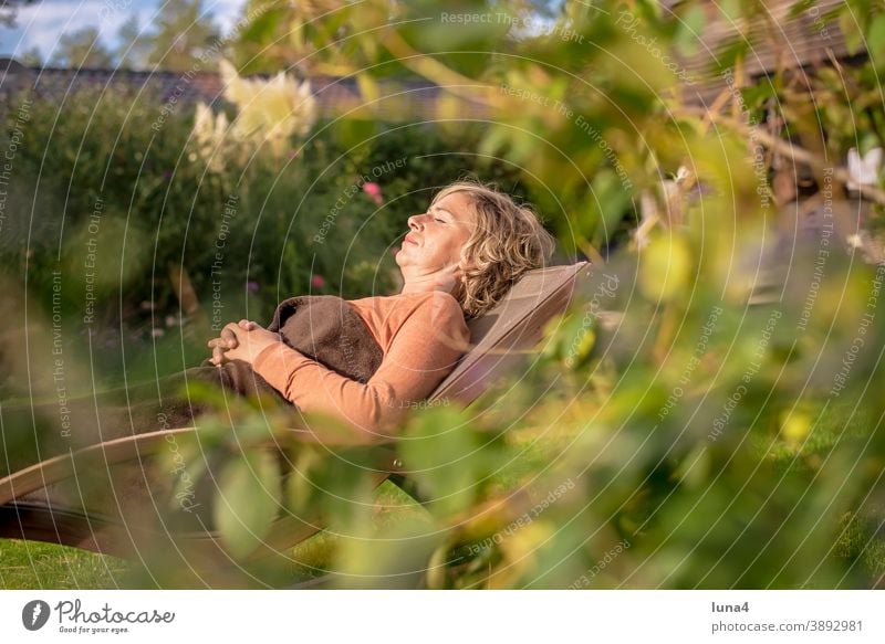 Woman lying in a deck chair Deckchair sunbathe Garden recover Sleep Rest relax To enjoy tranquillity Lie Autumn vacation holidays Sun Summer eyes closed