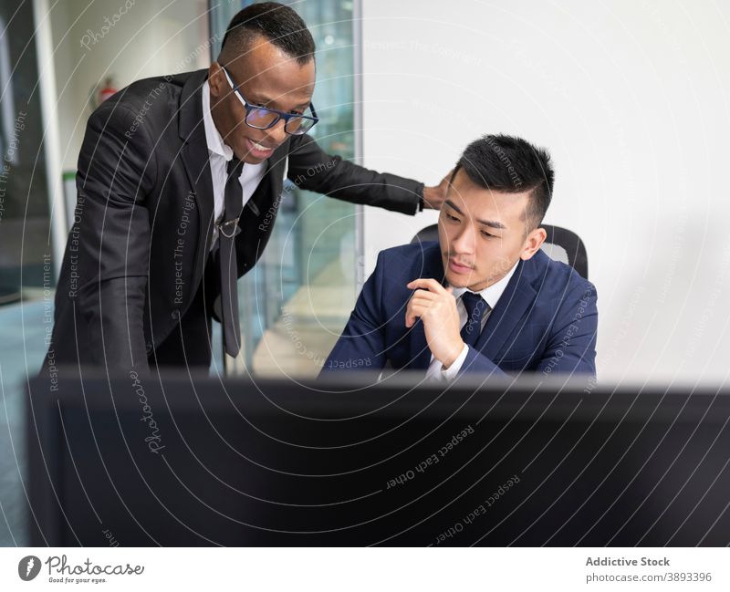 Business leader and manager discussing work problems in office businessmen boss laptop solution point show meeting serious young male asian african american