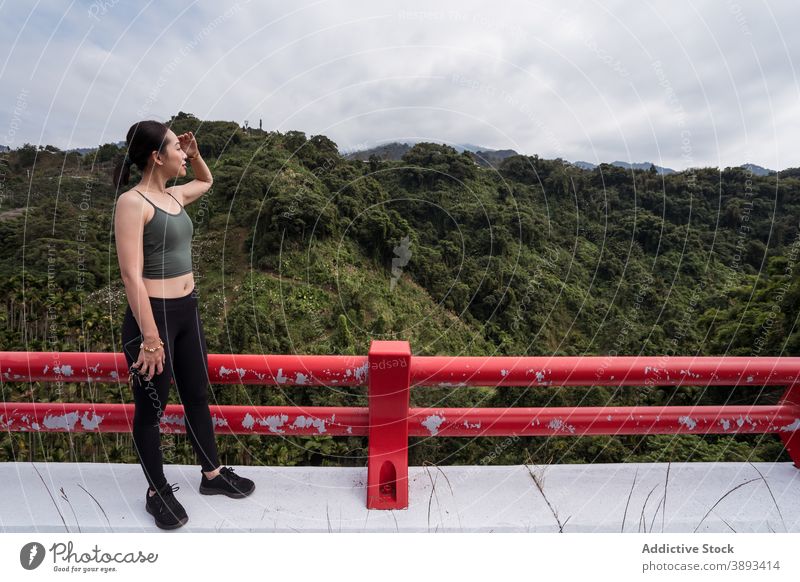 Asian woman enjoying view of mountain valley viewpoint highland traveler admire observe summer explore female ethnic asian taichung taiwan amazing green scenery