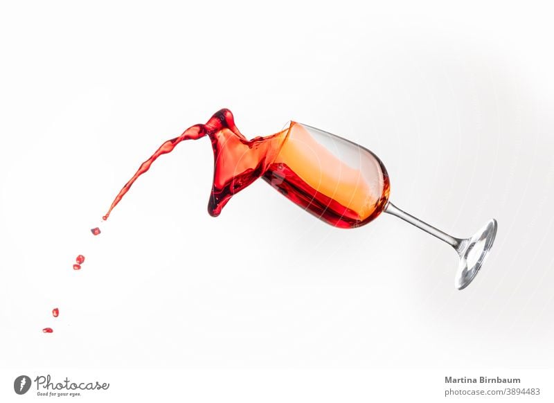Splashing red wine in a glass on white background splash gourmet object rose splashing liquid glassware merlot celebration drink goblet pour celebrate motion