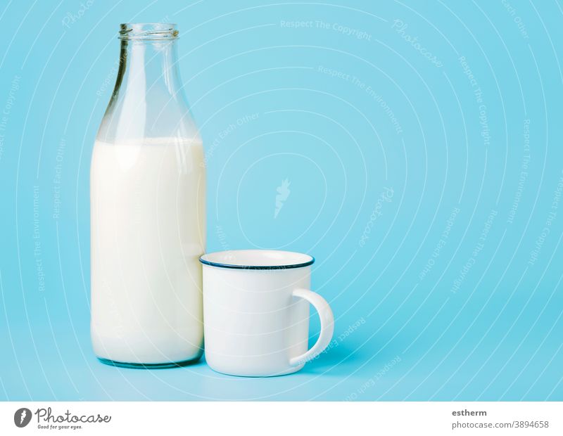 milk in a glass bottle and a white cup flow flowing cow fluid delicious healthy breakfast tasty yummy lunch nutrient protein diet still life kitchen ingredient