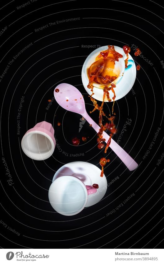 Falling pink coffee mugs and a spoon, spilling coffee with a splash pour motion hot drop object cup drink brown liquid beverage pastel espresso white isolated