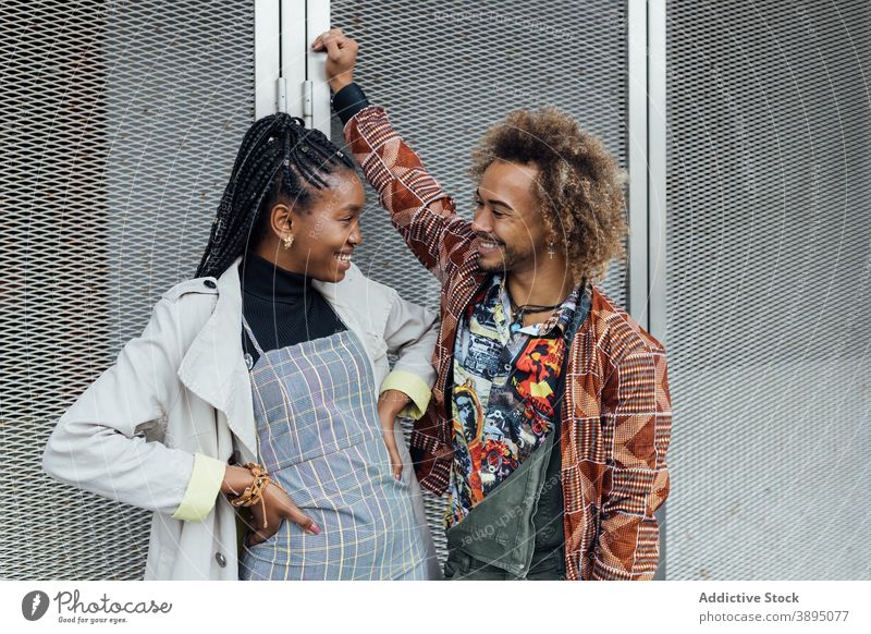 Cheerful ethnic friends talking on street cheerful chat happy trendy meeting couple urban positive young hipster style modern african american black friendship