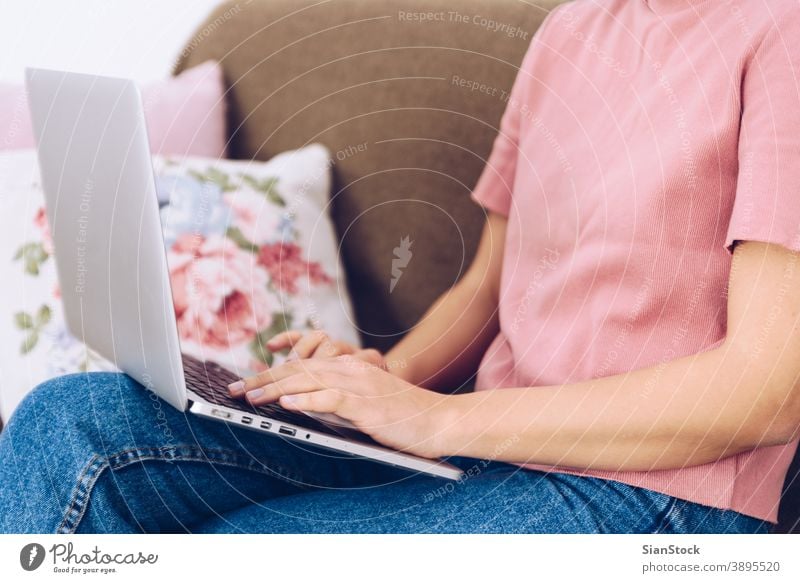 Young woman sitting on her sofa and working at her home. studying pillow carpet interior beautiful portrait room looking adult internet view communication
