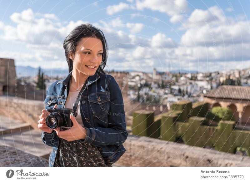 Young woman with camera in Granada, Spain granada tourist pretty 30s 30-35 years people one woman only person women lifestyles attractive caucasian La Alhambra
