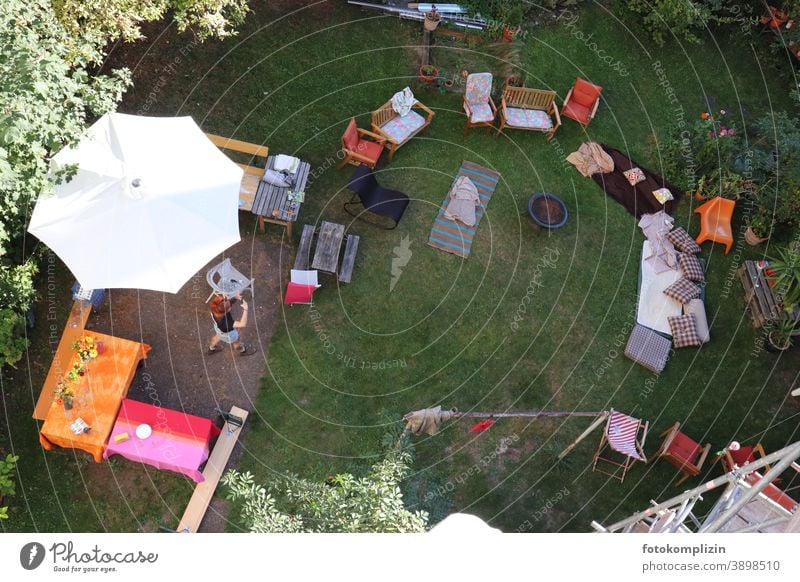 View from above into a garden with tables, chairs and mattresses for a garden party Garden festival Summerfest Firm Party guests Empty primed Targeted