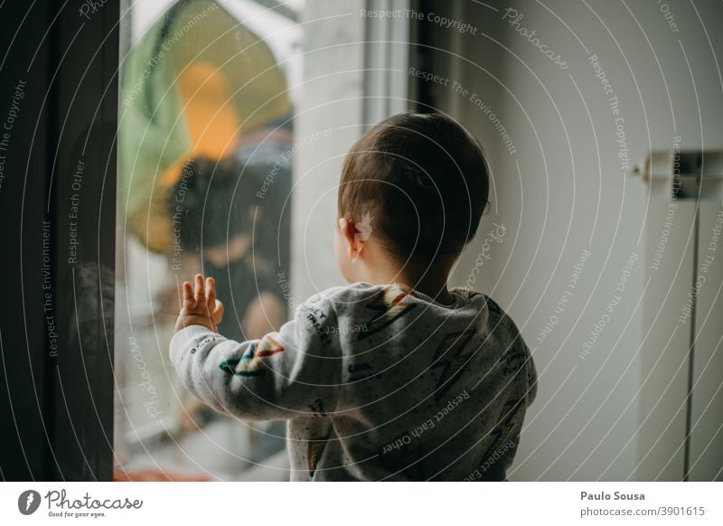 Child watching Mother through the window childhood Toddler Caucasian Rear view through window caucasian Day Family & Relations Human being kid 1 - 3 years
