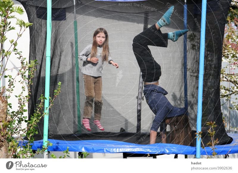 Trampolinists air jump blonde child fun girl high hop joy laughter leisure Trampoline young