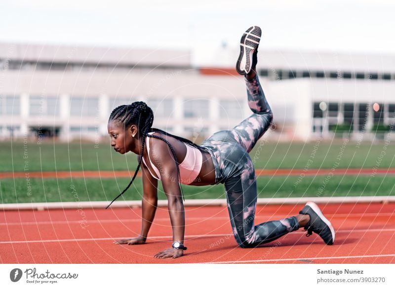 Athlete sprinter stretching her legs control race run competition athlete athletics competitive ready line beginnings compete competitor olympic olympics sports