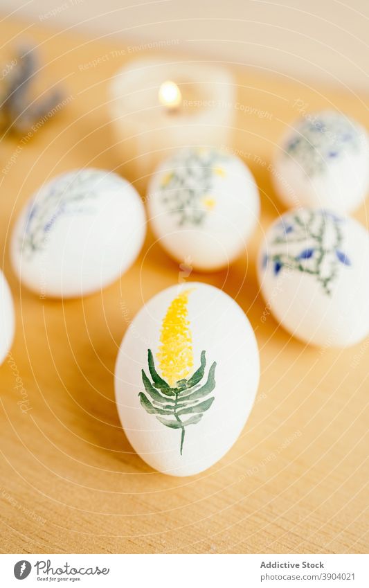 Various painted eggs arranged on table easter aquarelle flower holiday religious food tradition lavender candle spring religion decor color set collection
