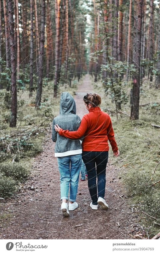 Mother and her little daughter walking in a forest during summer vacation trip active activity destination enjoy exploration female green hike lifestyle nature