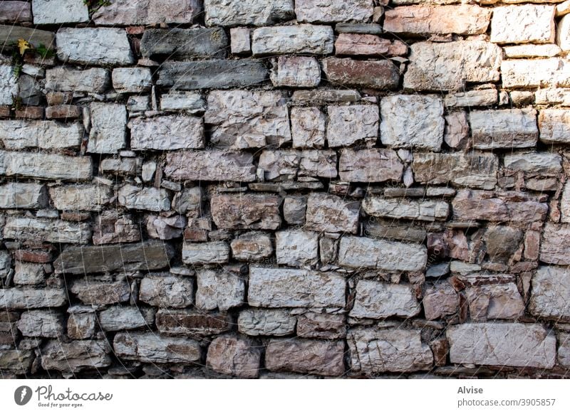 old wall with stones five build construct grunge grungy mess flooring tile tiling mortar prison obsolete stain decayed builder protective hard obstacle