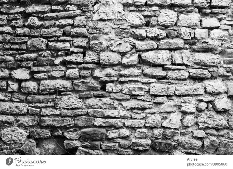 old wall with stones four build construct grunge grungy mess flooring tile tiling mortar prison obsolete stain decayed builder protective hard obstacle
