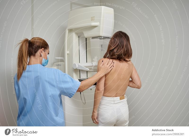 Doctor preparing patient for fluorography in hospital chest nurse radiology x ray diagnostic examine doctor check up health care clinic help support medic women