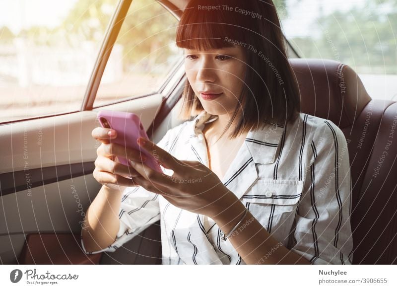 Young asian passenger woman using her smartphone at back seat car, transportation and lifestyle concept attractive auto automobile beautiful cellphone chatting