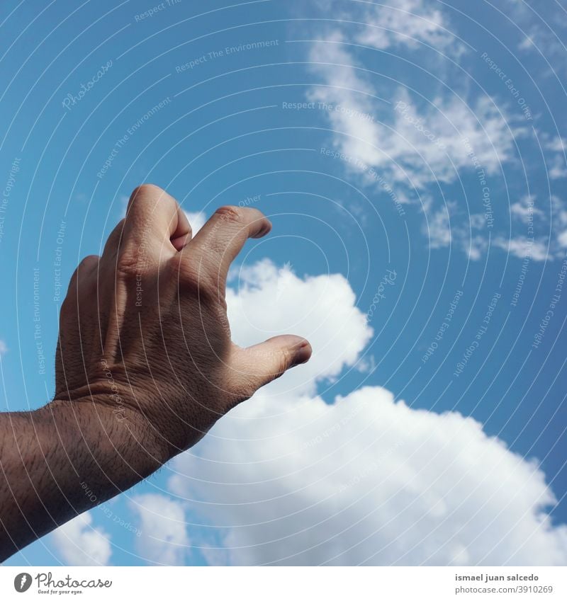 hand and clouds arm fingers skin palm body part sky blue touching feeling reaching pointing gesture gesturing concept freedom Human being Palm of the hand