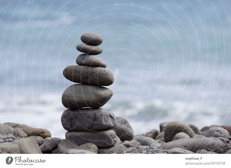 stone stack, tower or pyramid of stones on the beach, balance spirituality sea meditation harmony stone man guide Steinmännchen stable stability stacking