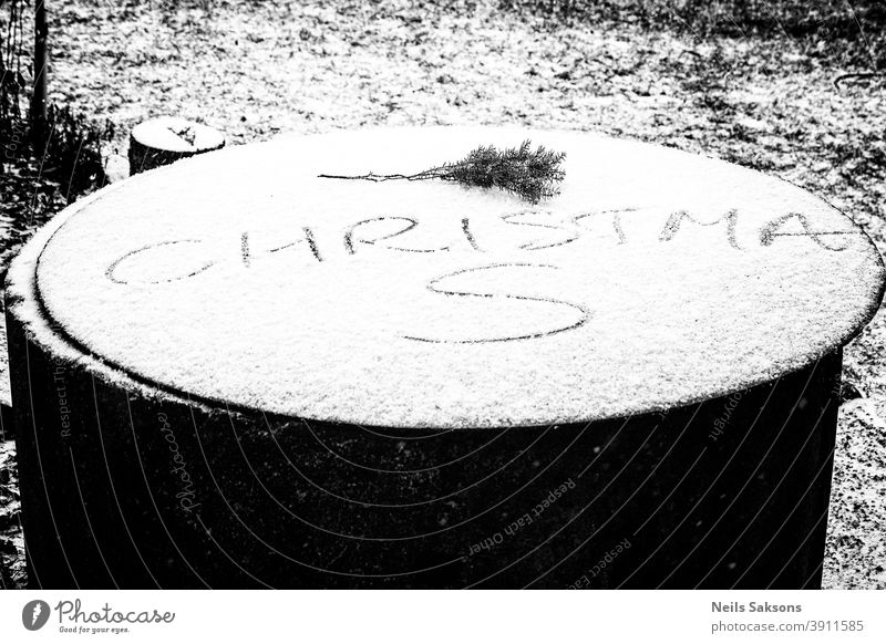 inscription Christmas in the snow on well cover christmas fir branch Juniper juniper branch winter december first snow Winter Christmas & Advent Decoration