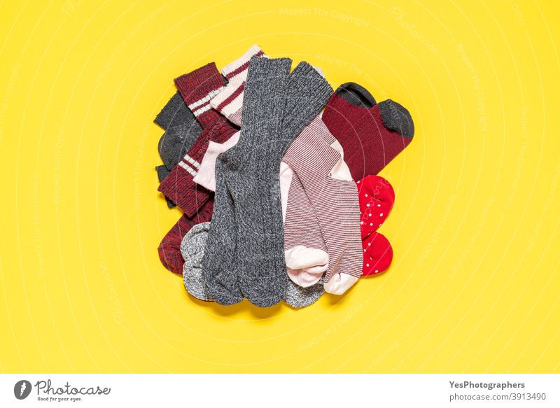 Pile of socks on a yellow background. Top view with many socks. above view accessories assortment bundle clothing cloths colorful copy space cotton cut out