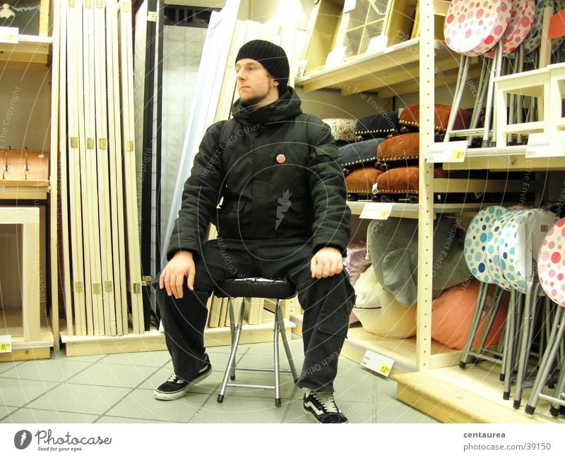 Invitation to sit Shopping Relaxation Calm Masculine Man Adults Observe Sit Sadness Grief Longing Loneliness Comfortable Chair ramschladen demonstrate ...