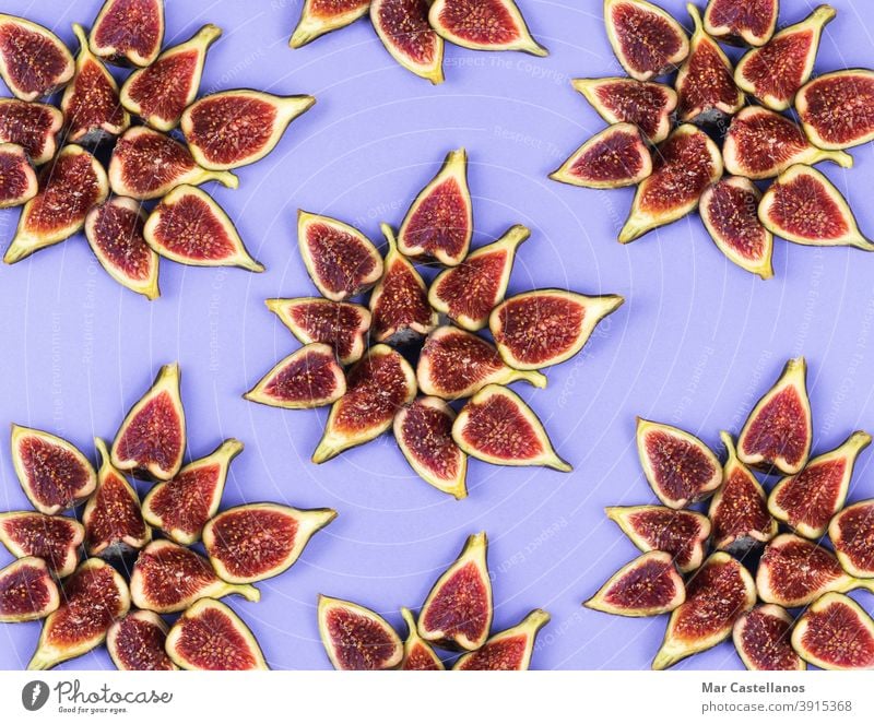 Stars of cut figs on a blue background. Copy space. Flat lay. flat lay breakfast snack ripe fruit group star top view purple tasty piece delicious sweet