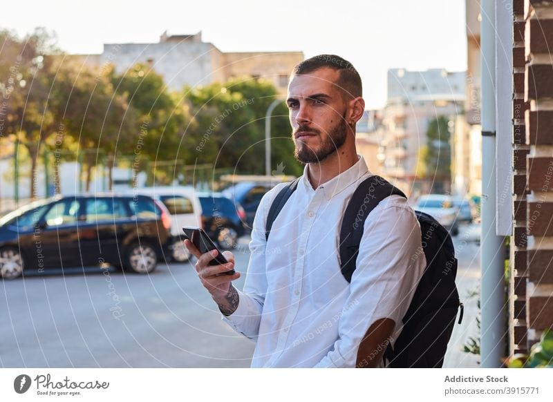 Man with bicycle using smartphone in city man urban trendy mobile street hipster serious adult male lifestyle gadget connection device bike modern communicate