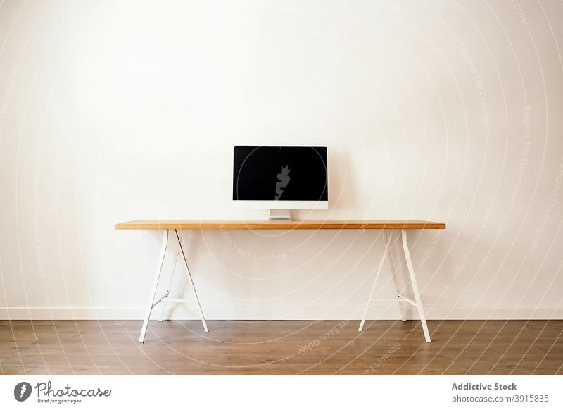 Minimalist workplace with modern computer minimal table interior furniture desk simple style device workspace gadget business lifestyle monitor freelance empty
