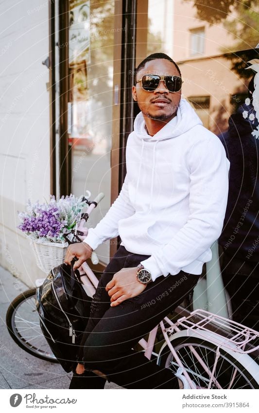 Black man in trendy outfit near bicycle in city style bike sunglasses cool street male ethnic black african american decorative modern urban young apparel