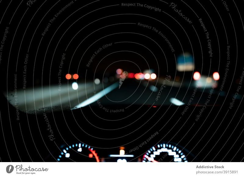 Car driving on night roadway car drive dashboard panel dark illuminate windshield auto trip highway vehicle transport automobile speed route windscreen travel