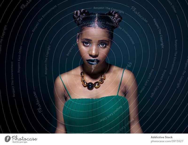 Young black woman looking at camera fashion style tradition colorful african portrait model ethnic young female appearance vivid afro lady hairstyle hairdo