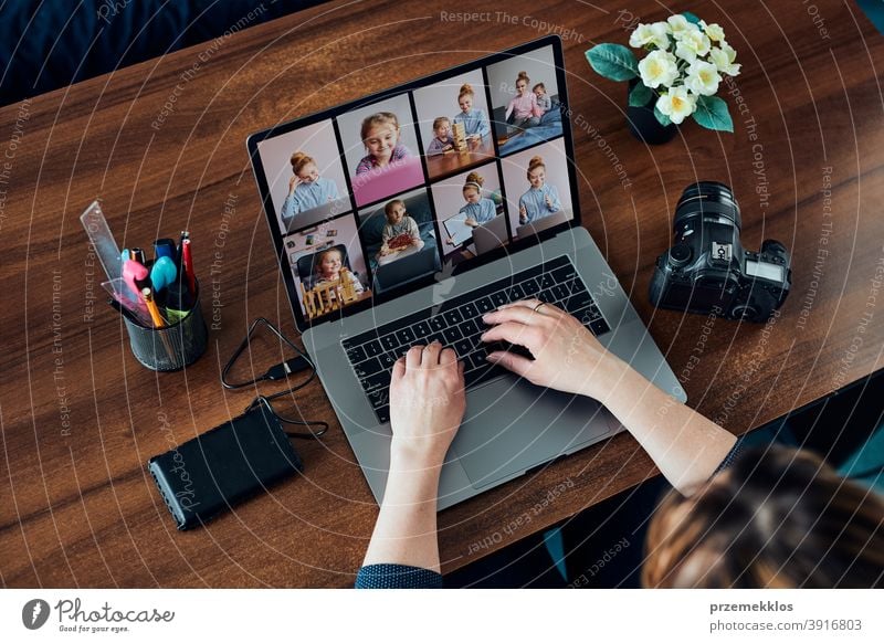 Female photographer working on photos on laptop and camera entrepreneur caucasian office creative photography person woman notebook modern indoors table female