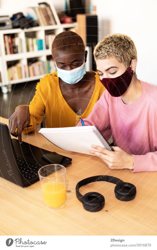 Businesswomen with protective mask using laptop togetherness discussion indoors business computer homosexual coronavirus online shopping learning buying