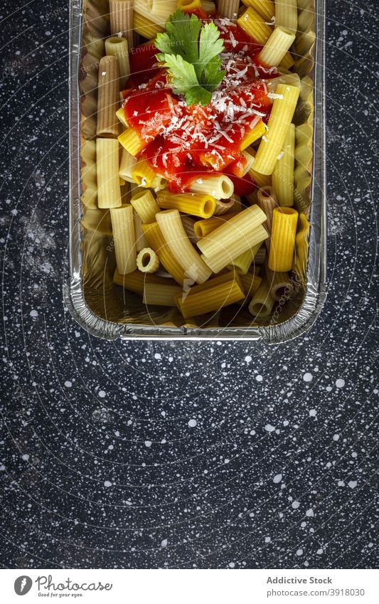 Tasty takeaway pasta in container on table macaroni food to go ketchup delicious lunch plastic fork meal tasty cheese yummy cuisine nutrition dish portion fresh