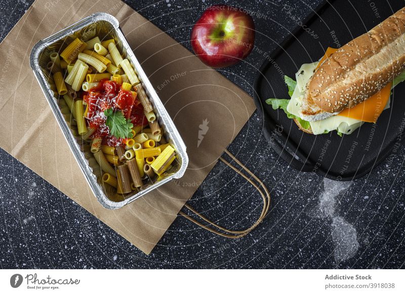Set of takeaway food for lunch on table pasta sandwich apple convenient package to go set meal fruit delicious nutrition dish eat gastronomy culinary yummy