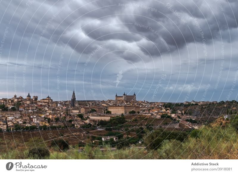 Cityscape with aged buildings in evening old city historic architecture cityscape sunset cloud hill castle stone toledo town ancient spain exterior cloudy sky