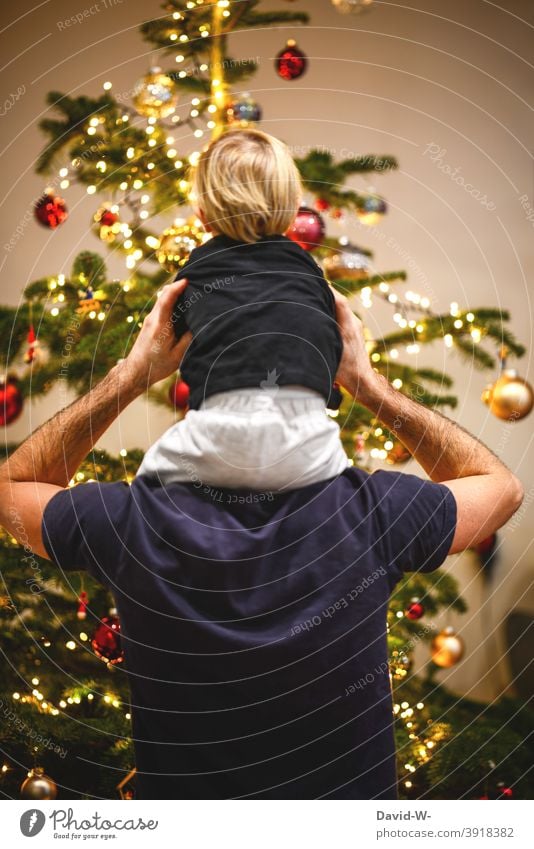 Father and child in front of the decorated Christmas tree Christmas & Advent Child Family christmas eve Together Parents Joy in common fortunate