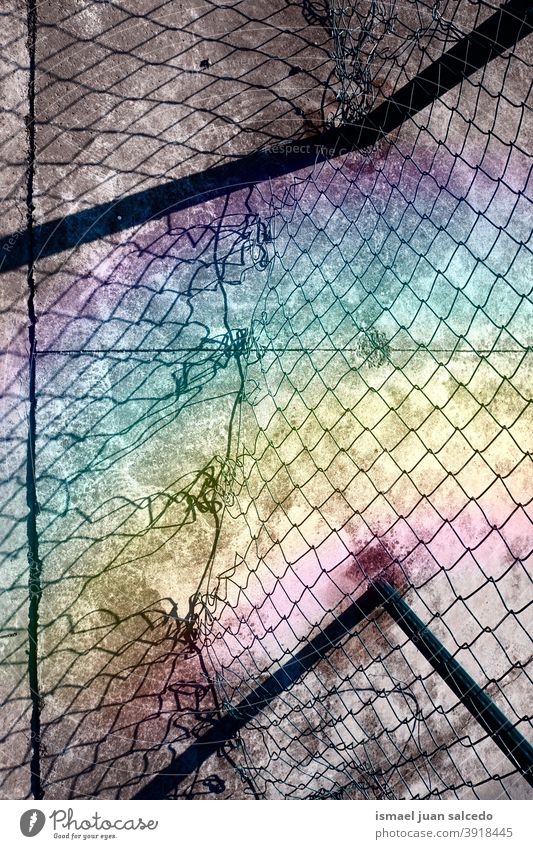 old broken metallic fence, rainbow and shadows Fence Old Ground textured pattern background Abstract Rainbow Sunlight abstract surface industrial Industry wall