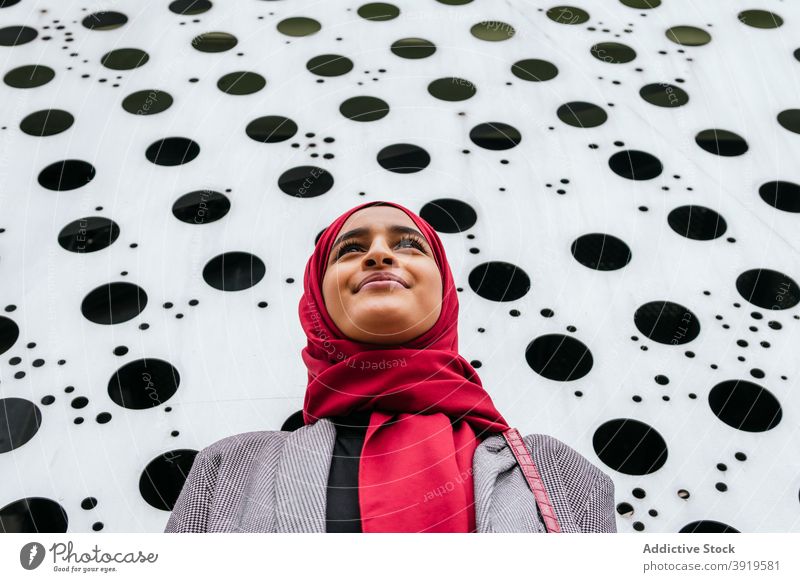Stylish ethnic woman in hijab on street headscarf smile urban modern cheerful city charming female arab tradition glad optimist positive happy pleasant lady joy
