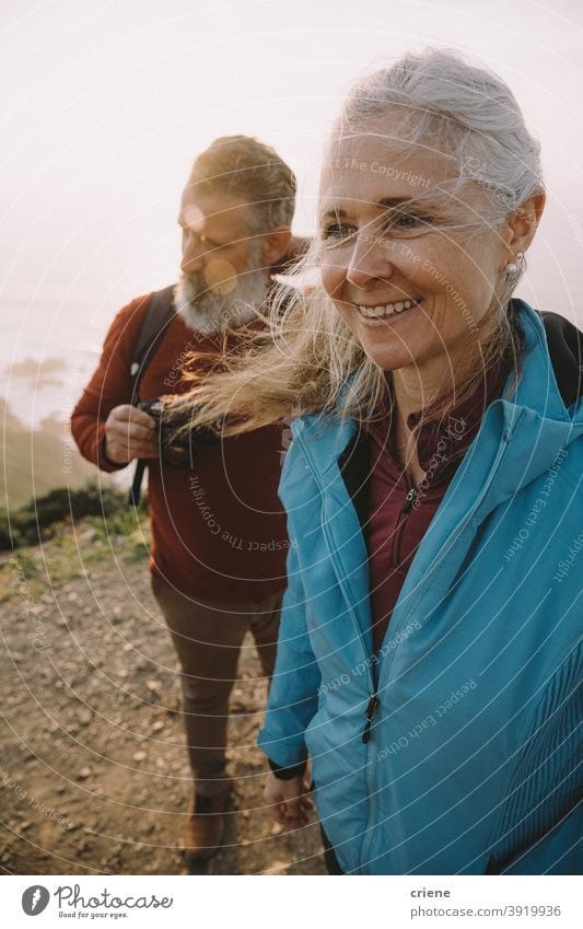 happy senior couple hiking together at sunset old elderly woman people love family smiling beach portrait mature retirement grandmother outdoors smile doctor