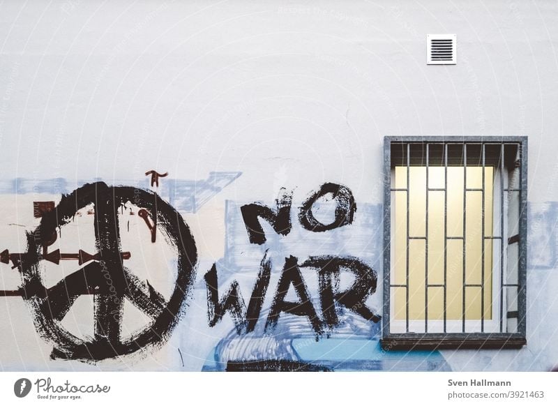 Graffiti on wall with window peace War Peace No War was Window Grating latticed Force Wall (building) Gray Exterior shot Wall (barrier) Characters Colour photo