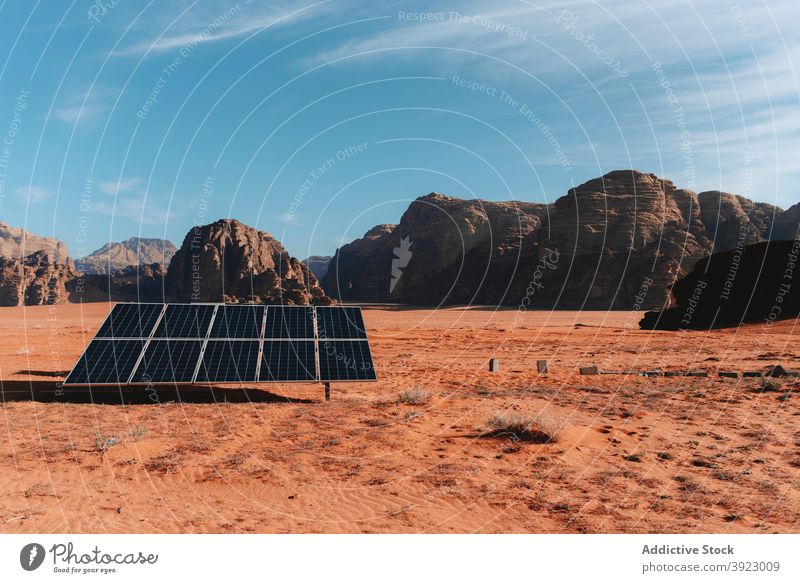 Solar battery placed in desert on sunny day solar panel renewal energy resource sustainable alternative power wadi rum jordan dry valley sandstone arid