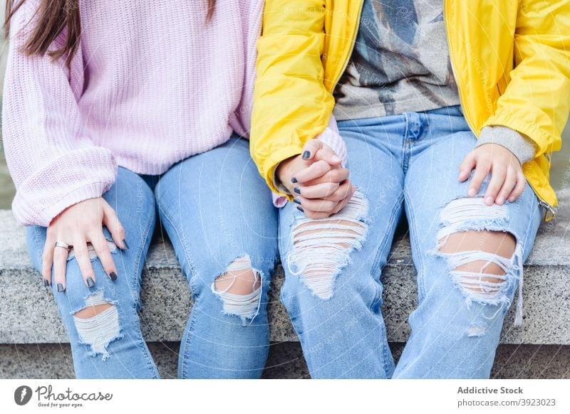 Crop lesbian couple holding hands on street women gay lgbt trust equal tolerance same sex female love in love stone bench sit city together lgbtq relationship