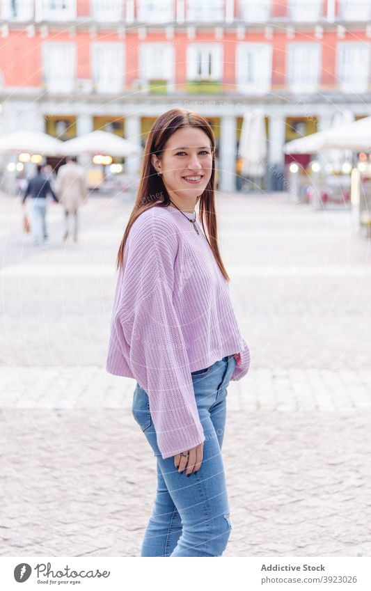 Woman in casual wear smiling at camera in city woman outfit smile street charming cheerful weekend young female style urban happy modern relax trendy joy