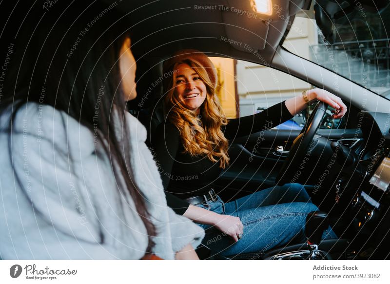 Women sitting in modern car in city women friend together talk driver passenger friendship automobile interior female seat contemporary happy smile communicate